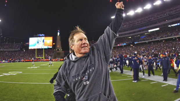 Bill Belichick runs off the Patriots’ home field in triumph.